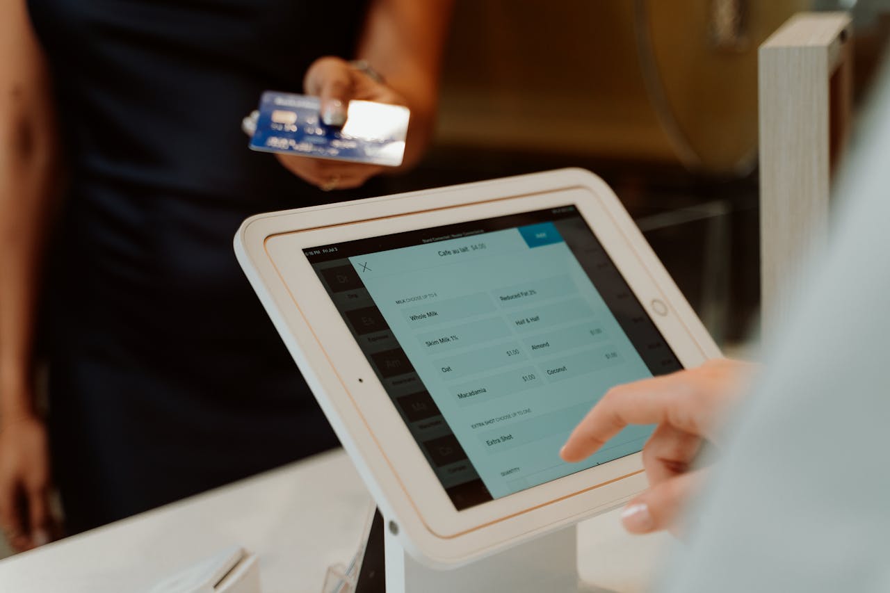 why-choose-us A modern cashless payment system using a tablet and card for seamless transactions.